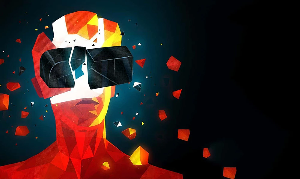 Геометрический портрет человека в VR-очки на темном фоне с разлетающимися цветными фрагментами.